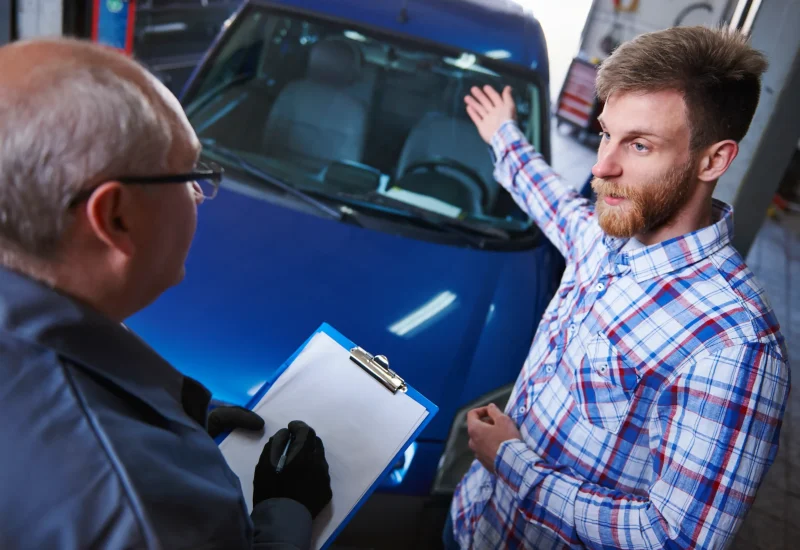 Vehicle owner discussing a vehicle with an appraiser